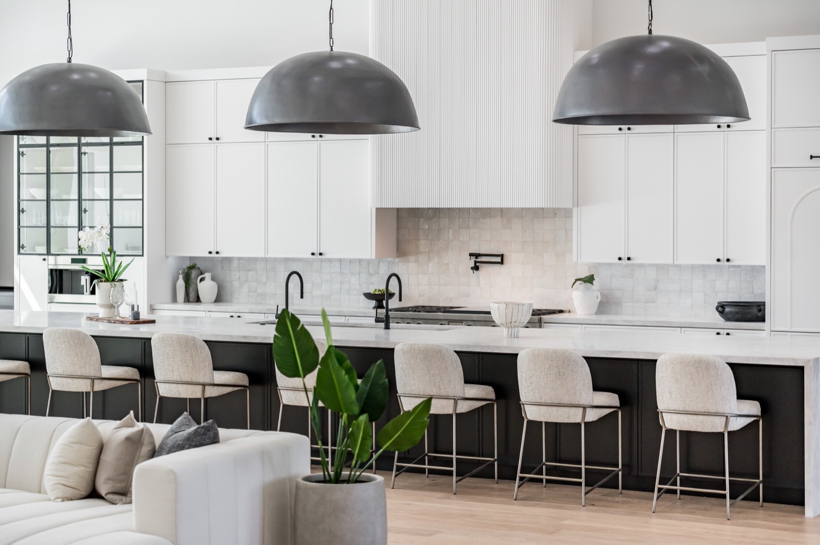 White kitchen and black island seen from the front