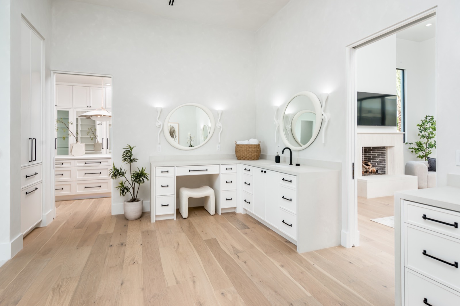 White vanity with a round mirror
