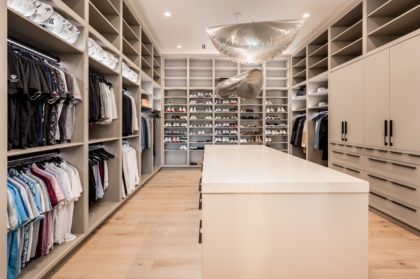 Dressing room with open hanging, shelving and a central island