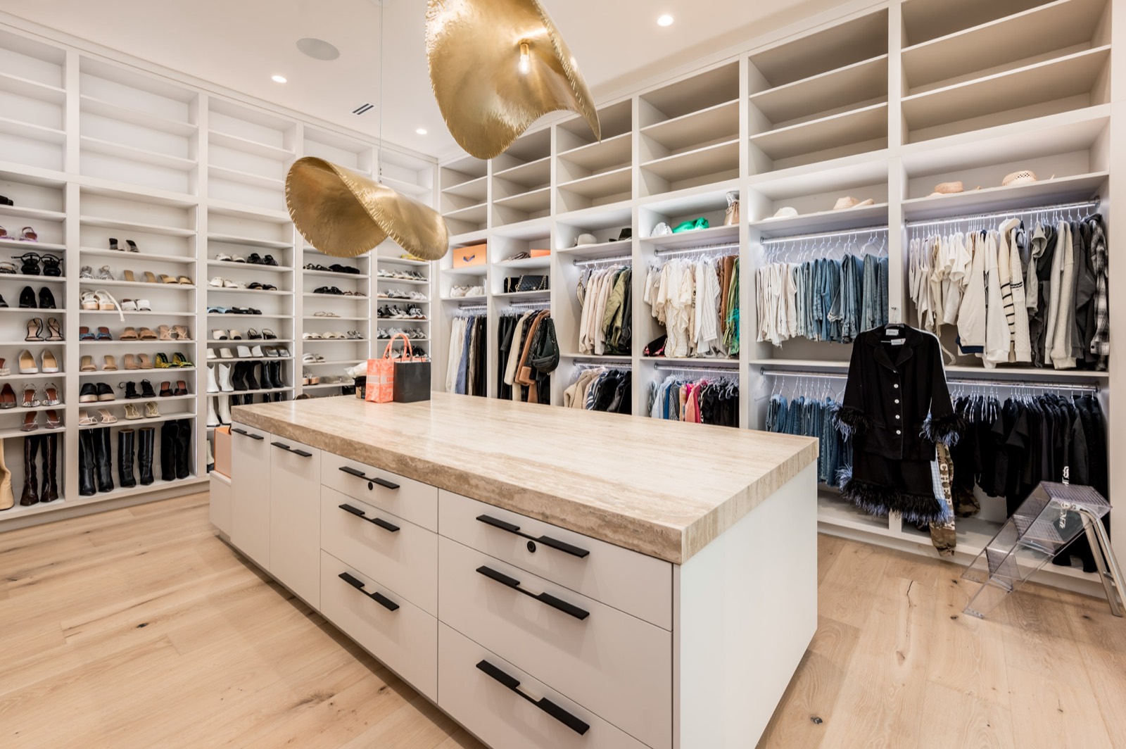 Boutique-style dressing room with a brass pendant and island