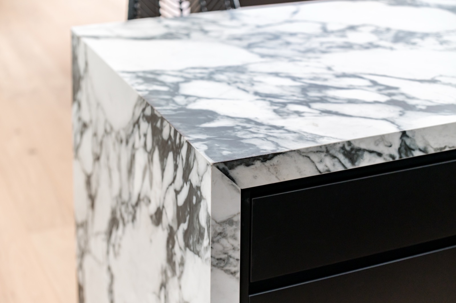 Close detail of a veined marble waterfall edge