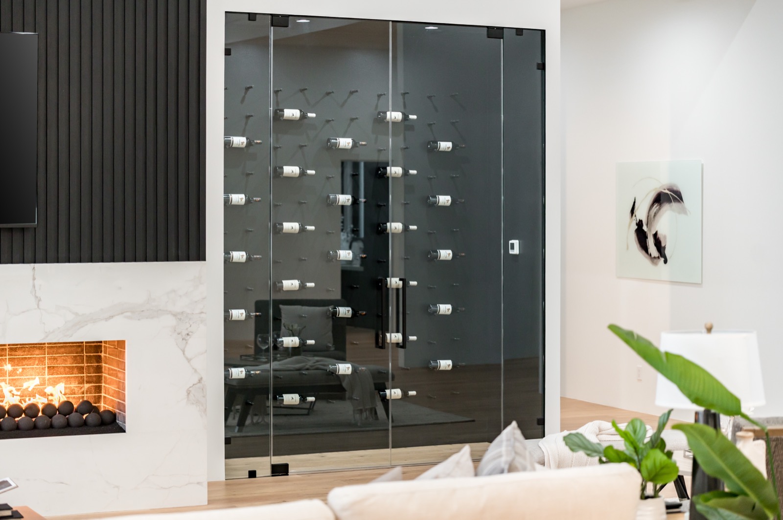 Glazed wine room beside a fireplace