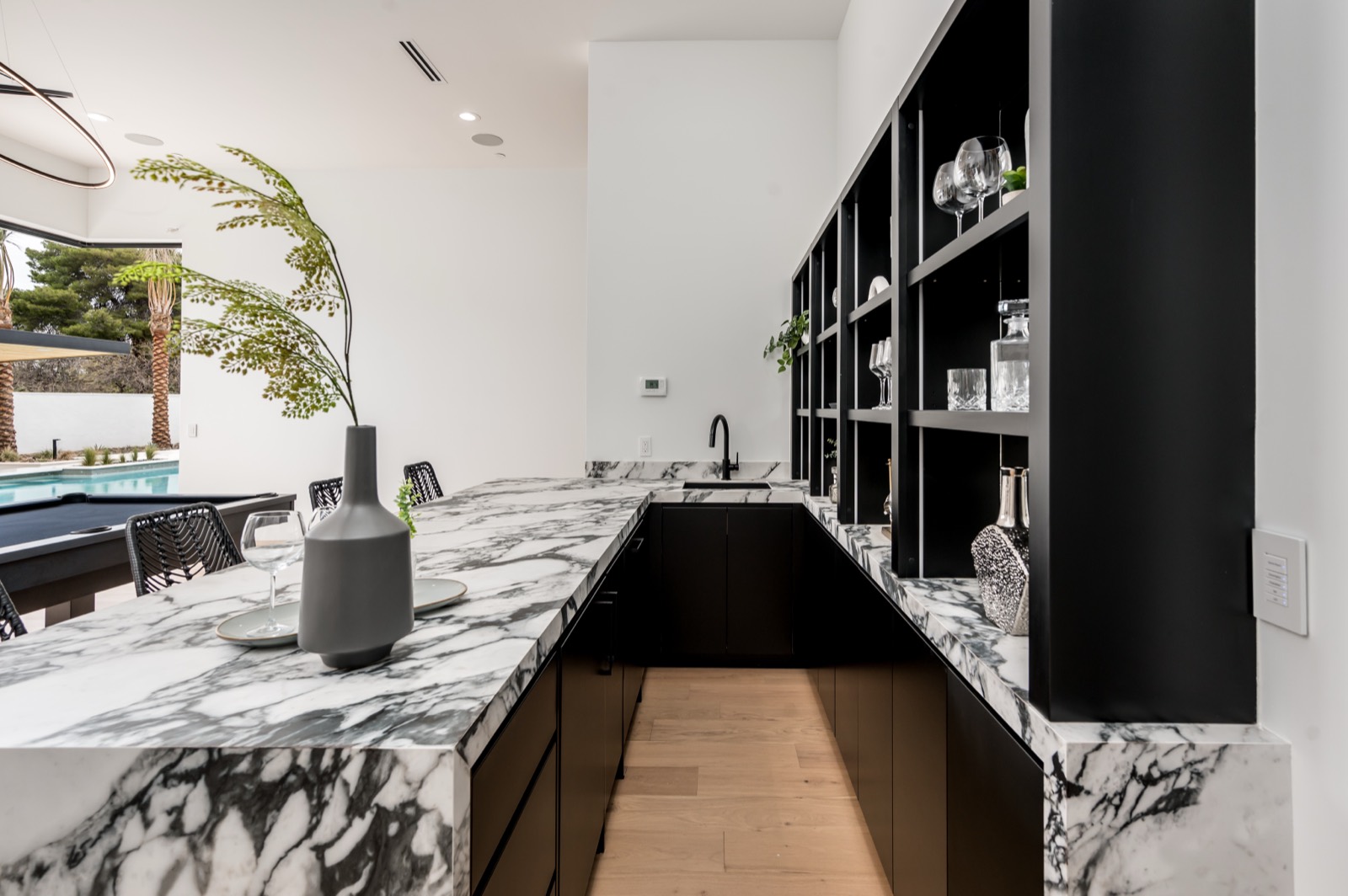 Bar with black cabinetry and a bold marble counter