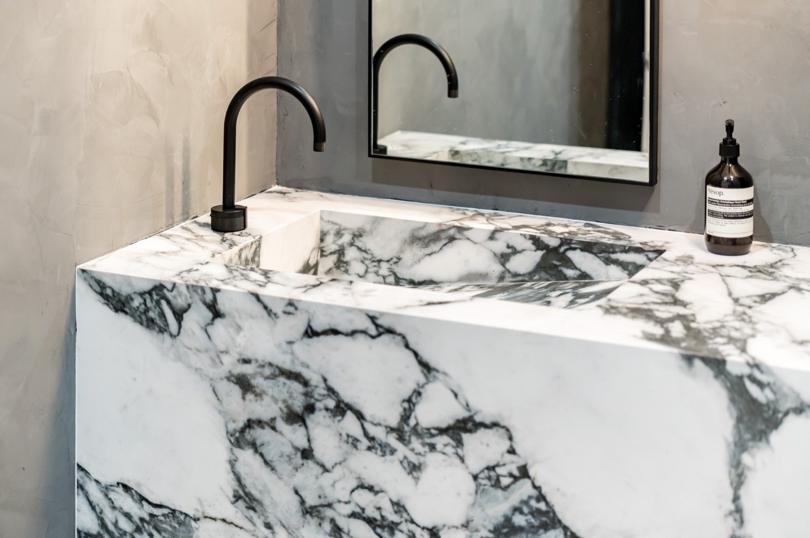 Marble-wrapped powder room vanity