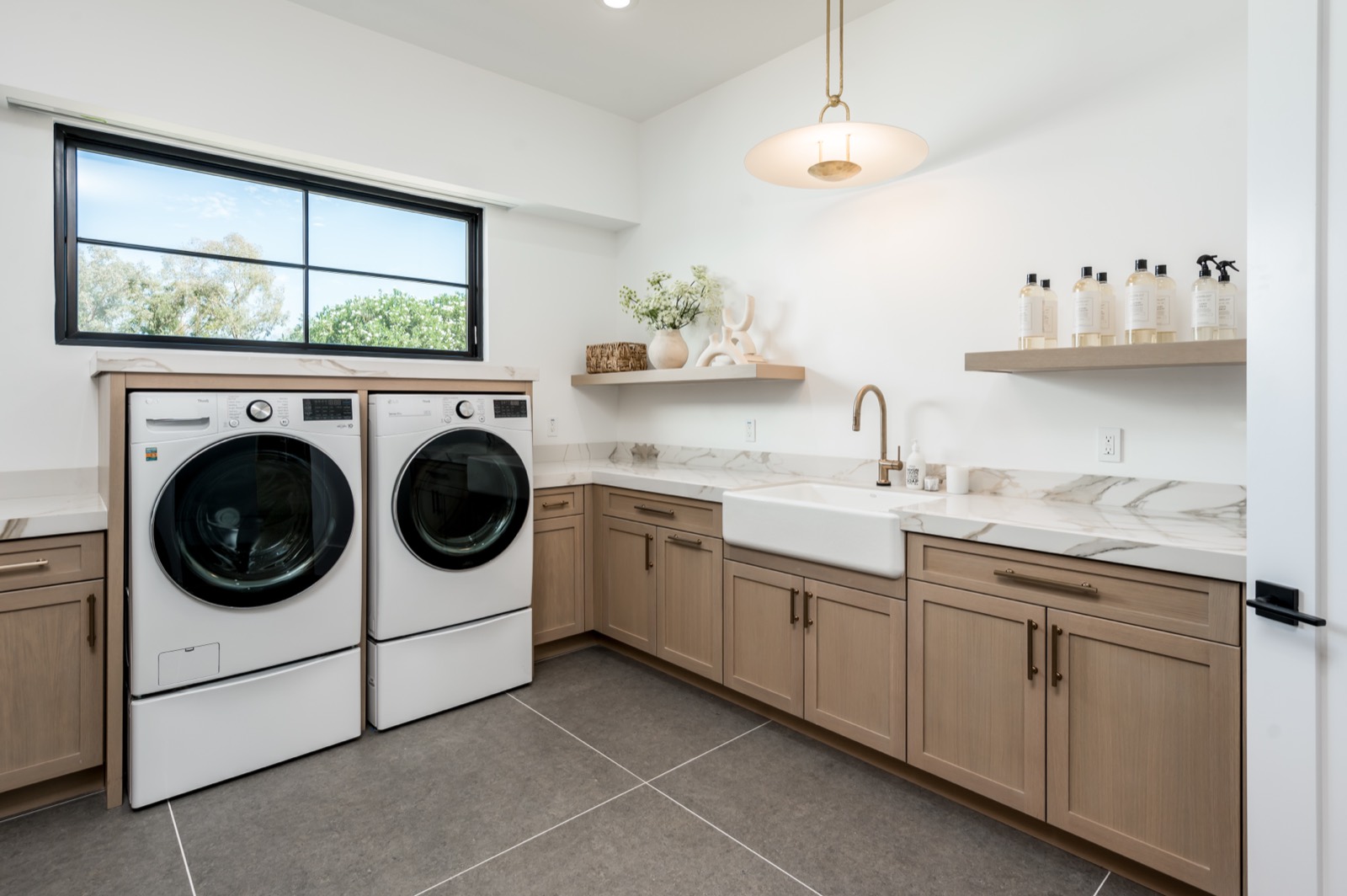 Oak laundry with front-loading machines and a sink