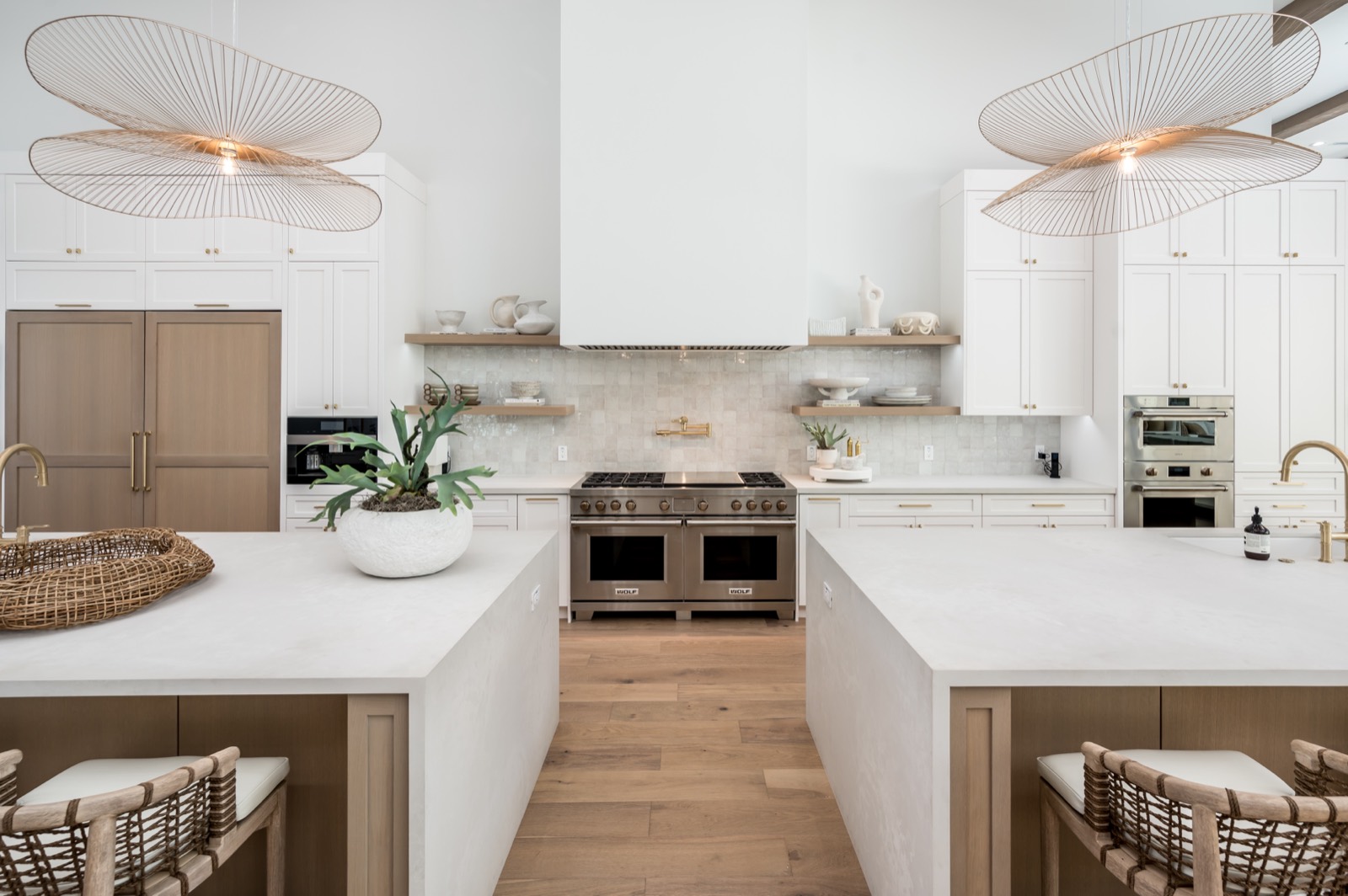 Kitchen with oak islands and woven stools