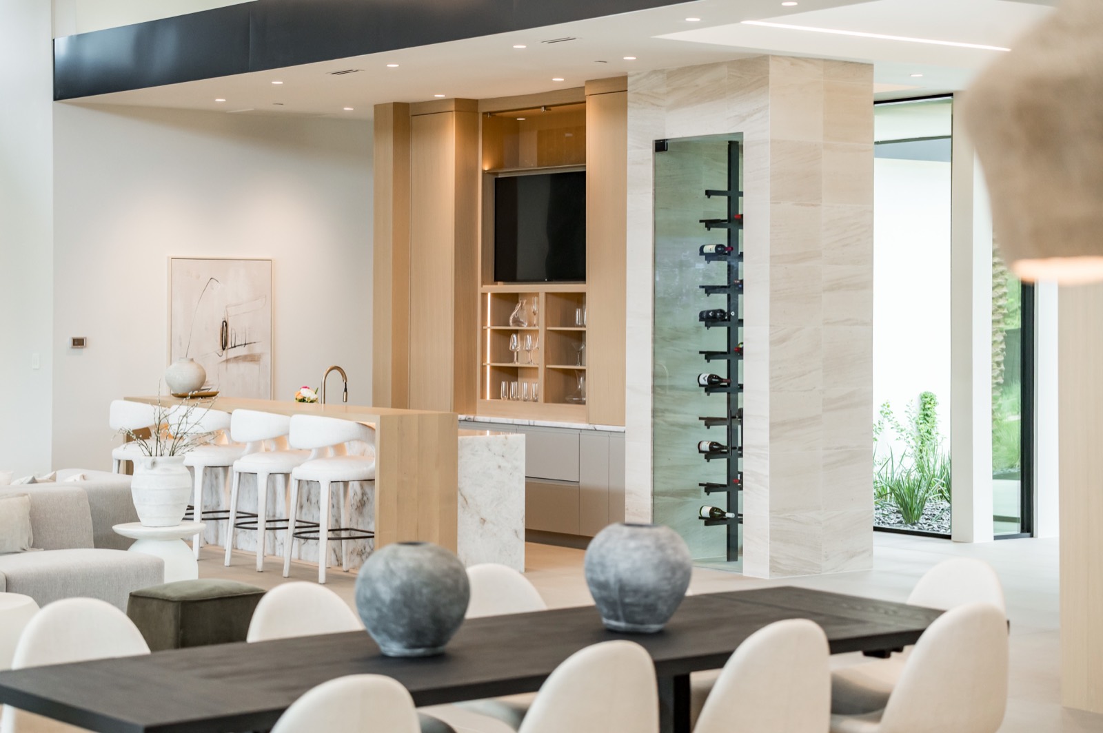 Open-plan family room with oak built-ins and a wine column