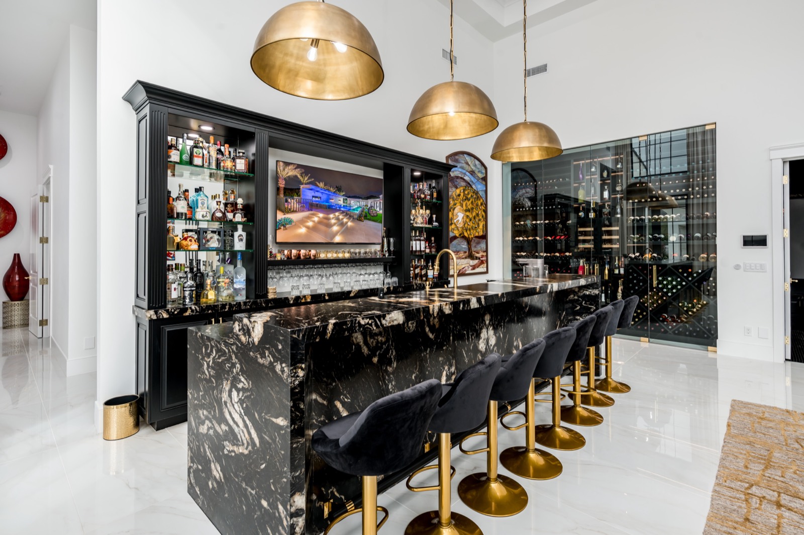 Black bar with brass dome pendants and lit back-bar shelving
