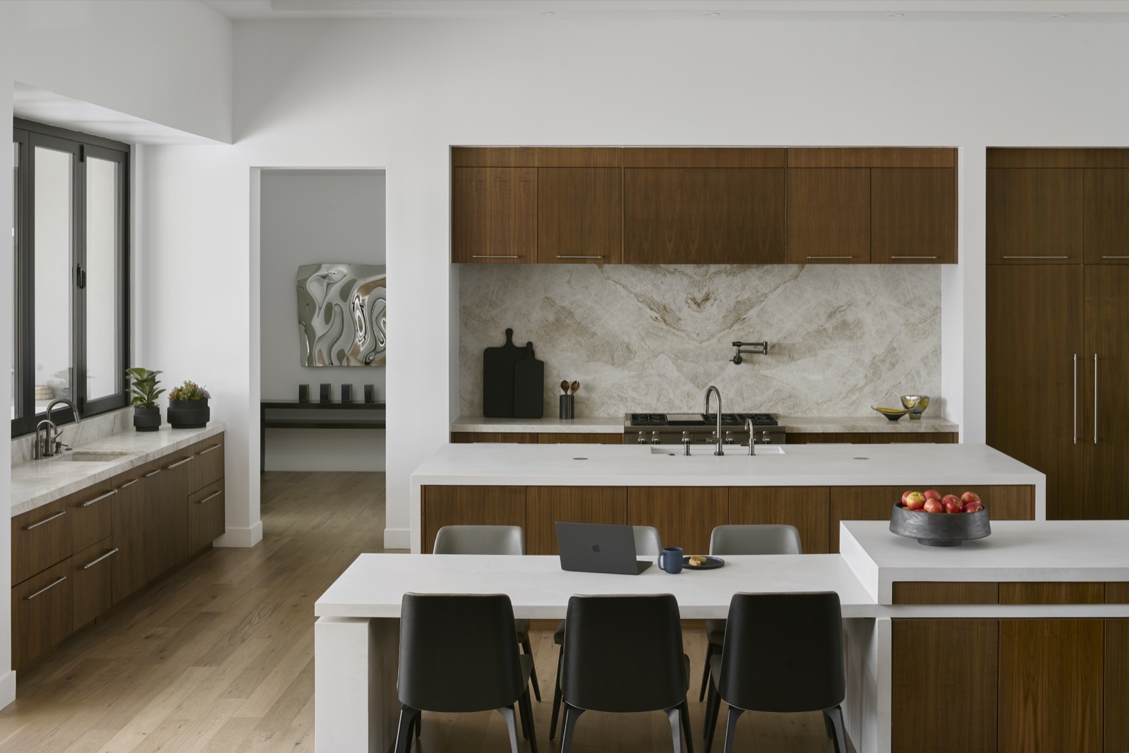 Kitchen with walnut uppers and a stone backsplash