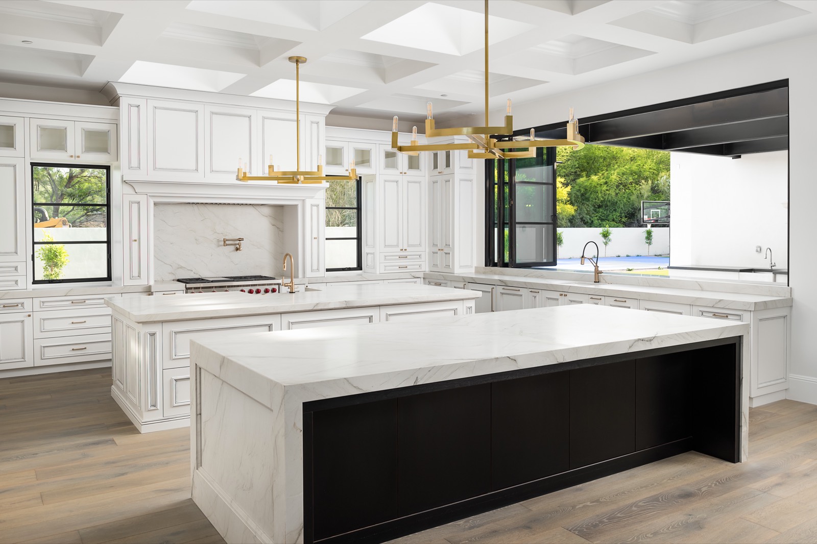 Wide view of the white kitchen and black island