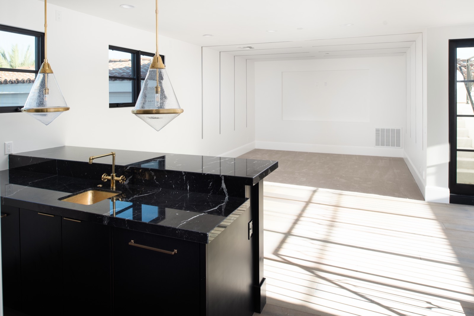 Black bar cabinetry beside a staircase